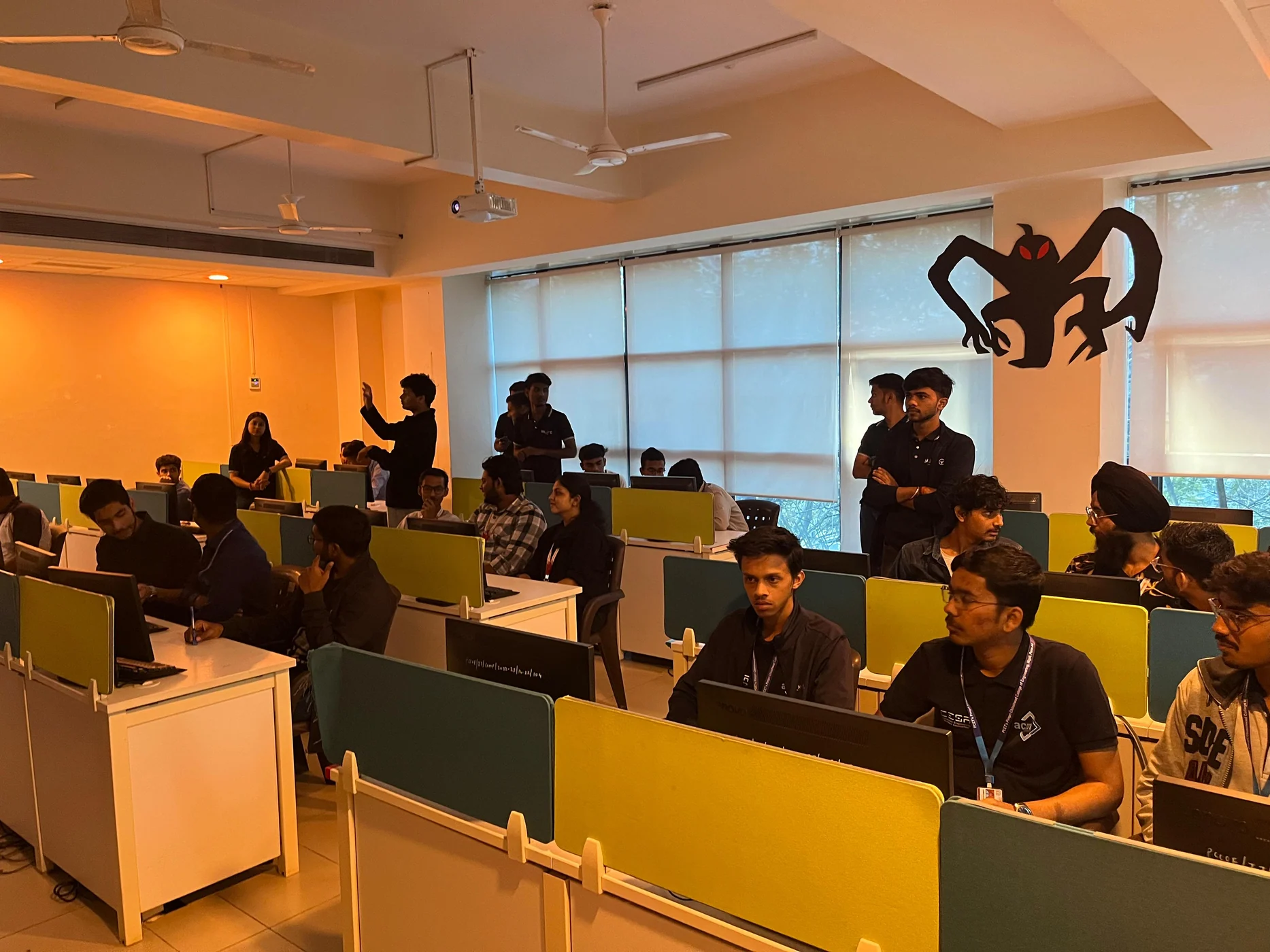 Participants working together at computer stations in a bright event room