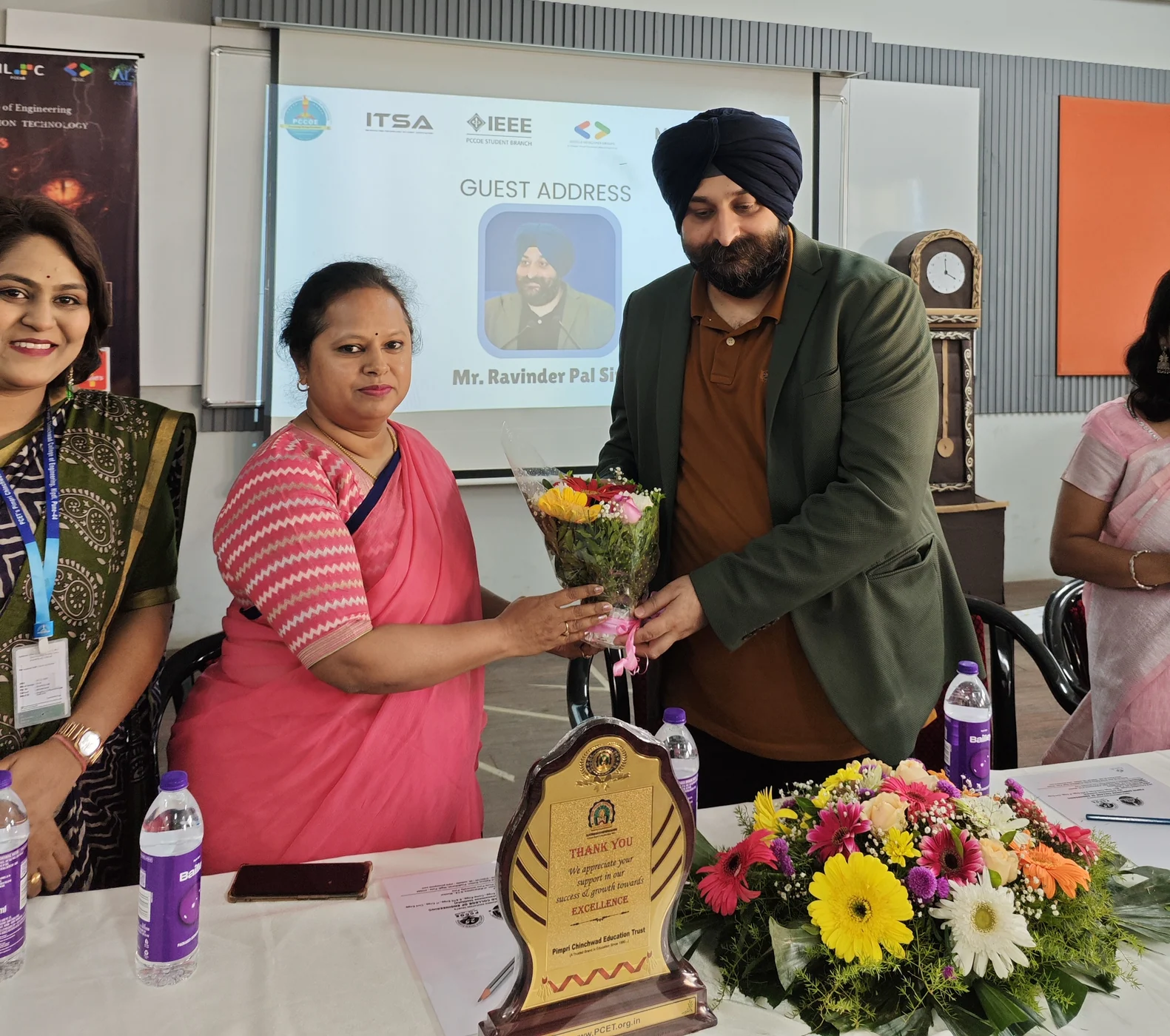 A faculty member presenting flowers to the Praxis guest speaker